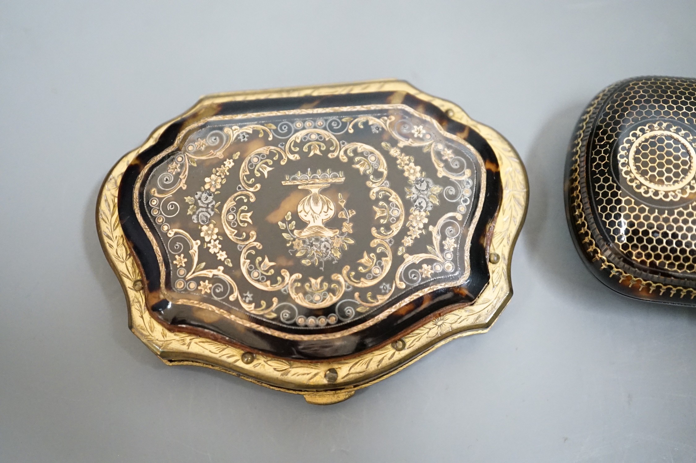 A 19th century finely worked tortoiseshell piqué work purse, with blue silk lining and a similar git metal edged piqué work purse